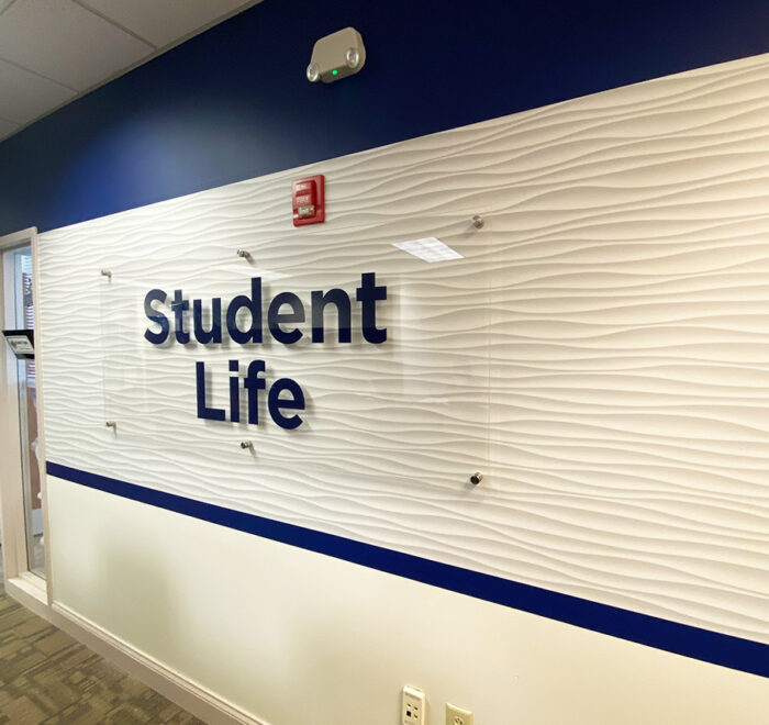 Daemen College wall wrap and acrylic sign